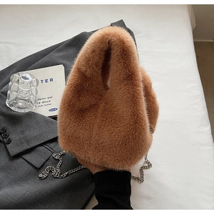 Detailed view of plush brown faux fur bucket bag with elegant silver metal chain strap