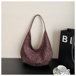 Close-up of leopard print tote bag in soft suede-like fabric with a matching shoulder strap