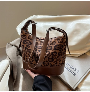 Dettaglio del tessuto scamosciato leopardato e patchwork in pelle marrone sulla borsa