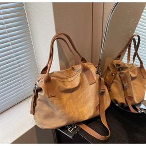 Detail of retro brown canvas tote bag showing high-quality stitching and metal hardware