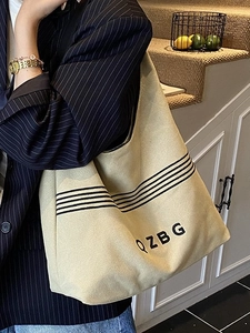 Minimalist beige canvas shoulder bag with black stripes and QZBG logo for women