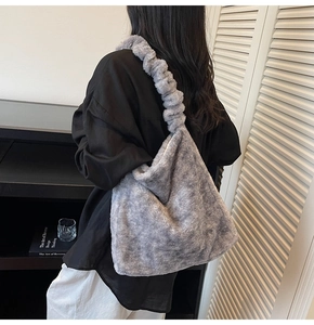 Detail of plush grey faux fur tote bag with ruffled shoulder strap and puffy cloud shape
