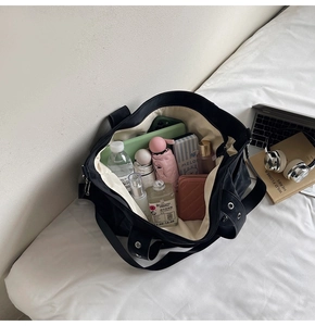 Spacious black canvas tote bag interior showing large storage capacity and inner lining