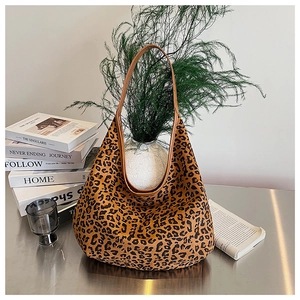 Close-up of leopard print tote bag placed on a metallic surface with decor