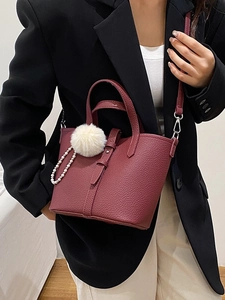 Elegante borsa a secchiello bordeaux in pelle con pompon e ciondolo di perle