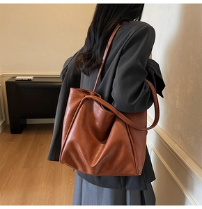 Caramel brown large tote bag made of premium leather shown from a back perspective