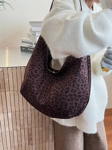 Large vintage leopard print tote bag in dark brown suede shown on model in cozy sweater