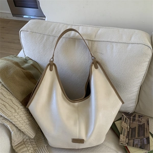 Detail of off-white large tote bag with brown edge oil finish on soft leather