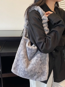 Stylish grey faux fur tote bag with ruched shoulder strap shown on a model