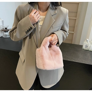 Detail of pink plush faux fur handbag with delicate chain strap and fuzzy handle