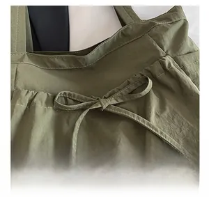 Detail of army green canvas tote with decorative ribbon knot and fine double stitching