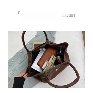 Interior view of brown leather tote bag showing large capacity for tablet and cosmetics