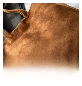 Detail shot of brown suede tote bag showing high-quality reinforced edge stitching