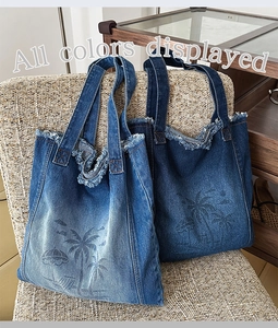 Detail showing two shades of denim tote bags with frayed edges and palm tree prints