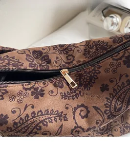 Close-up of vintage paisley print bag with a premium golden metallic zipper head