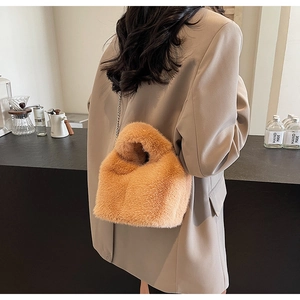 Detailed view of brown plush bucket bag with soft faux fur and silver chain strap