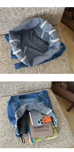 Detail view of denim tote bag showing interior stitching and large capacity storage