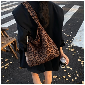 Chic oversized leopard print hobo bag with wide shoulder strap in autumn street style