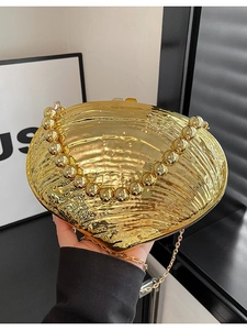 Elegant gold shell-shaped evening clutch bag with beaded handle and metal chain strap