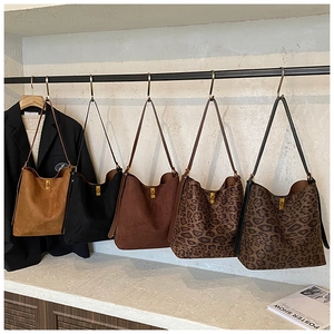 Collection of minimalist suede leopard print tote bags featuring iconic gold buckles