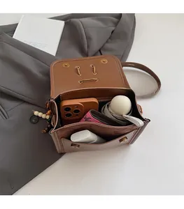 Detail view of the open brown vintage crossbody bag showing spacious interior capacity
