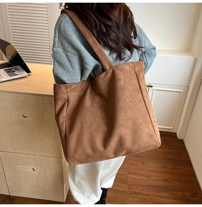 Detail view of the brown suede tote bag showing the soft texture and large capacity