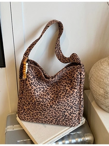 Large leopard print tote bag in retro style with wooden bead pendant on a vintage background