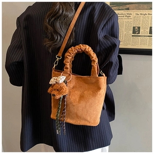 Caramel corduroy tote bag detail with ruched handle and cute plush dog charm