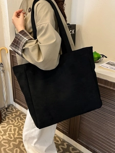 Minimalist black large capacity tote bag shown as stylish shoulder bag for daily commuting
