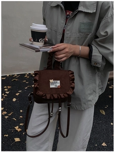 Detail of coffee brown leopard mini backpack with frill trim and cute bear patch