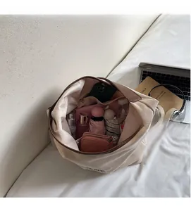 Interior view of the canvas tote bag showing large capacity for essentials like umbrella and wallet