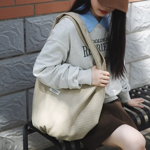 Dettaglio della borsa tote in nylon a quadretti gialli con etichetta JIASHUO all'aperto