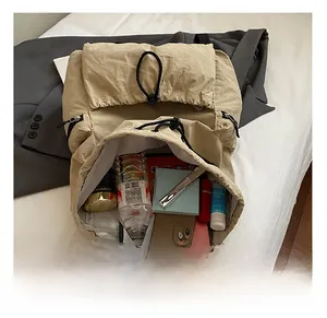 Vue interne d'un grand sac à dos kaki avec cordon de serrage montrant l'espace de rangement