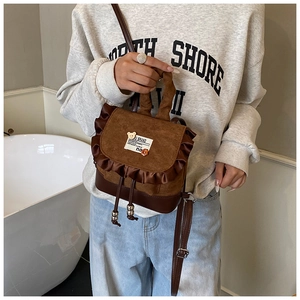 Detail of mini leopard backpack with ruffle trim, bear embroidery, and drawstring closure