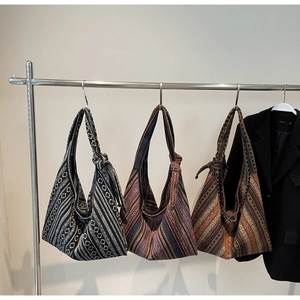 Detailed view of bohemian canvas tote bags with geometric jacquard patterns and knotted straps