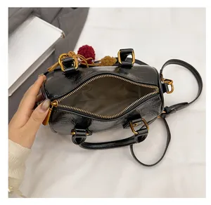 Interior view of black Boston cylinder bag showing spacious compartment and light lining