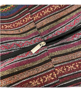 Detail view of the smooth silver metal zipper on the colorful ethnic striped canvas tote bag