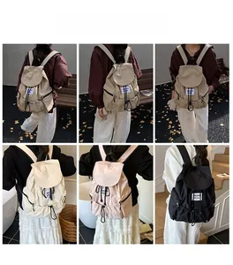 Detail view of lightweight nylon drawstring backpack in multiple colors on models