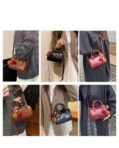 Detail view of retro mini Boston bags in brown black and burgundy with plush charms