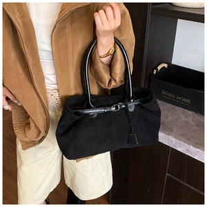 Detail of minimalist black faux suede tote bag with leather straps for daily commute