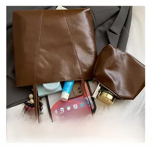 Detail view of brown faux leather tote showing large capacity for tablet and cosmetics