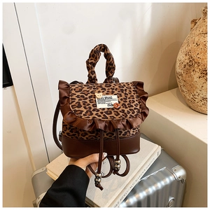 Detail of leopard print mini backpack with brown ruffles and metal beaded drawstring