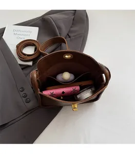 Interior view showing large capacity and inner pocket of brown leather crossbody bag