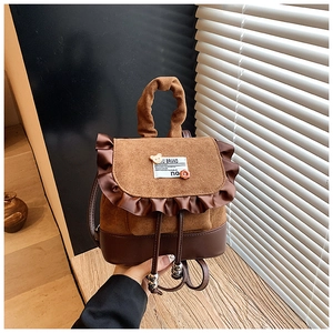 Detail view of mini leopard retro backpack with ruffle trim and cute bear charm