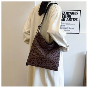 Hobo leopard print tote bag styled with cream coat and black adjustable shoulder strap