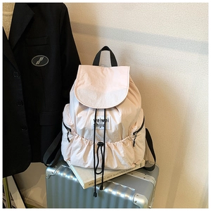 Macro shot of light pink nylon backpack texture with drawstring and flap closure details