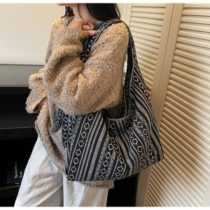 Close-up of ethnic style tote bag with black and white geometric patterns and wide strap