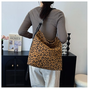 Detailed view of the large leopard print canvas tote bag on model for size perspective