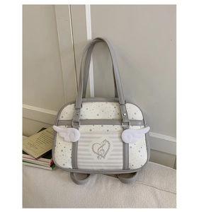 Detail of JK style faux leather shoulder bag featuring star prints and side wing accents