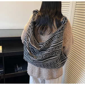 Close-up of ethnic style canvas bag with black and white geometric woven pattern